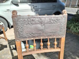 an antique leather chair repaired by leather surgeon onsite